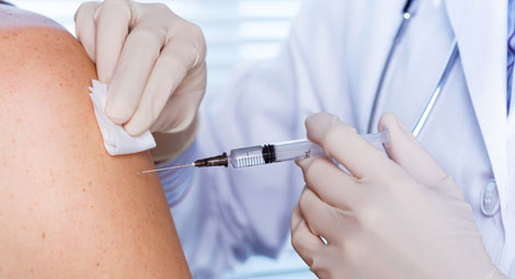 Person receiving an injection in their arm